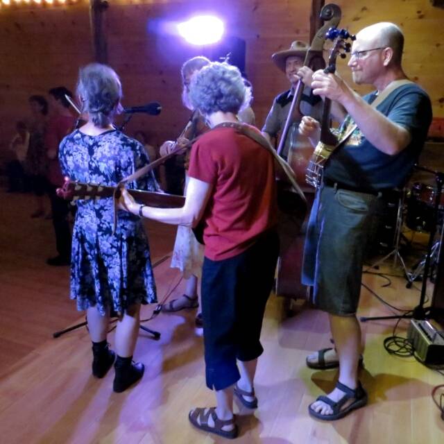 From John J.... Planet Banjo at camper's night square dance.... Kathy and Tii on fiddles, Jon on Banjo, Katie on guitar, Barry on bass, and Nancy calling.